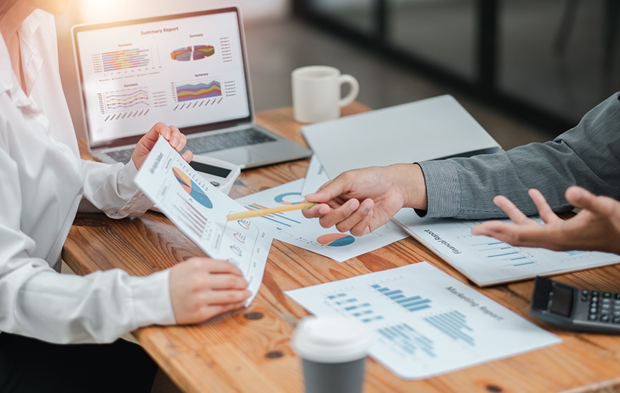 advisor and client looking at documents with charts